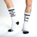 White crew socks with black text id fuck me and matching black stripes toe caps and heel accents