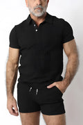 Black indio knit short sleeve polo shirt with white buttons and ribbed texture made from soft knit fabric