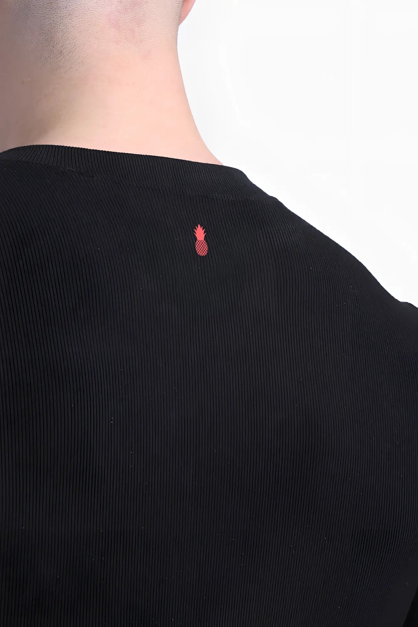 Back view of infinity long sleeve button up bodysuit in midnight black black corduroy with small red pineapple logo