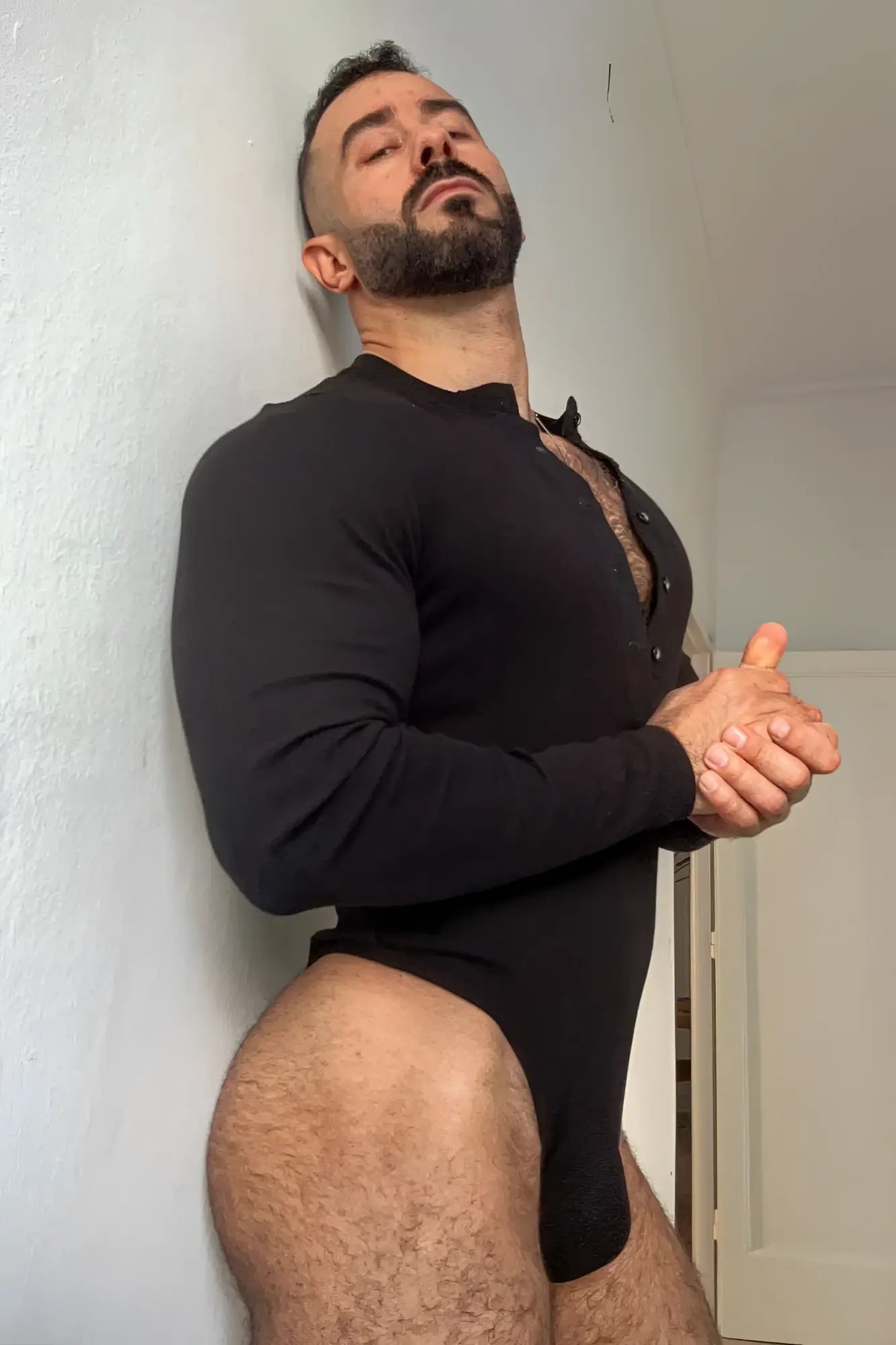 Black long-sleeved button-up bodysuit in midnight black with front buttons and fitted design
