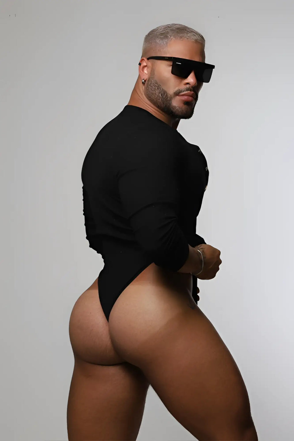 Black long-sleeved infinity bodysuit with button-up front and high-cut leg design in midnight black