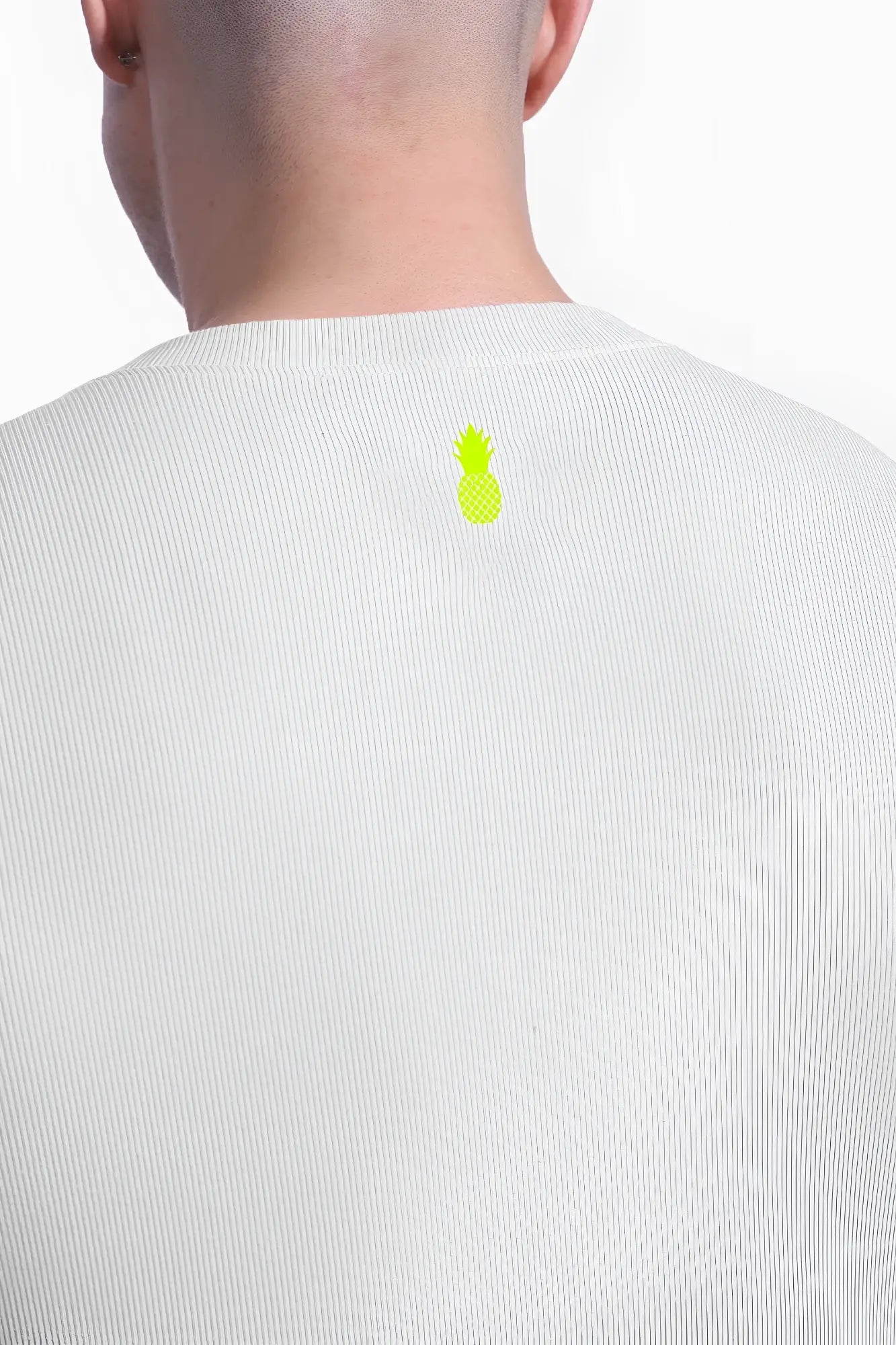 Back view of white ribbed cotton infinity long sleeve button up bodysuit with small neon green pineapple logo