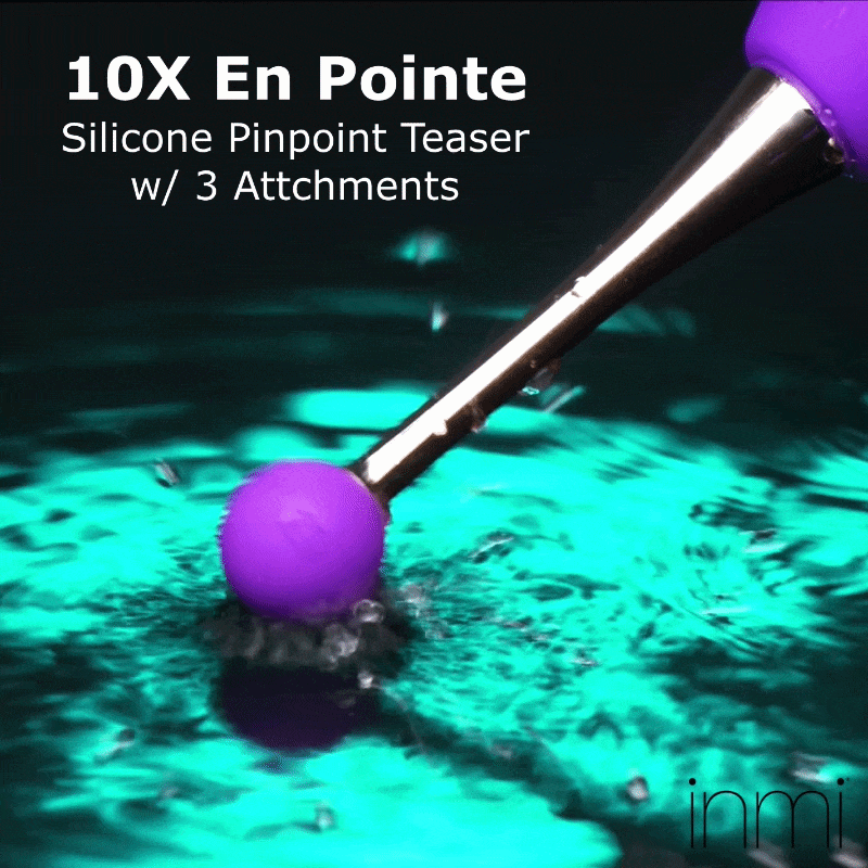 Inmi 10X En Pointe silicone teaser with a purple ball attachment dipping into glowing cyan water.