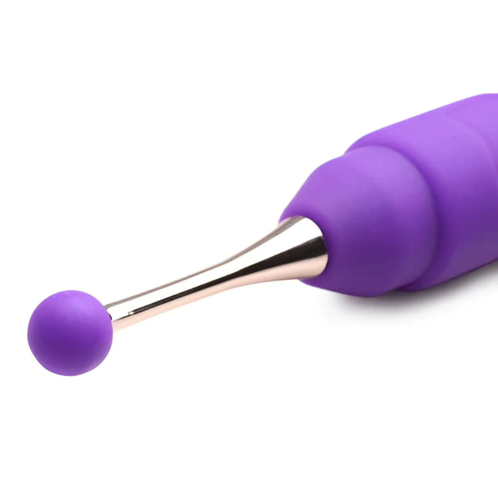 Inmi 10X En Pointe silicone teaser with a purple, spherical attachment on a metallic rose-gold stem against white.