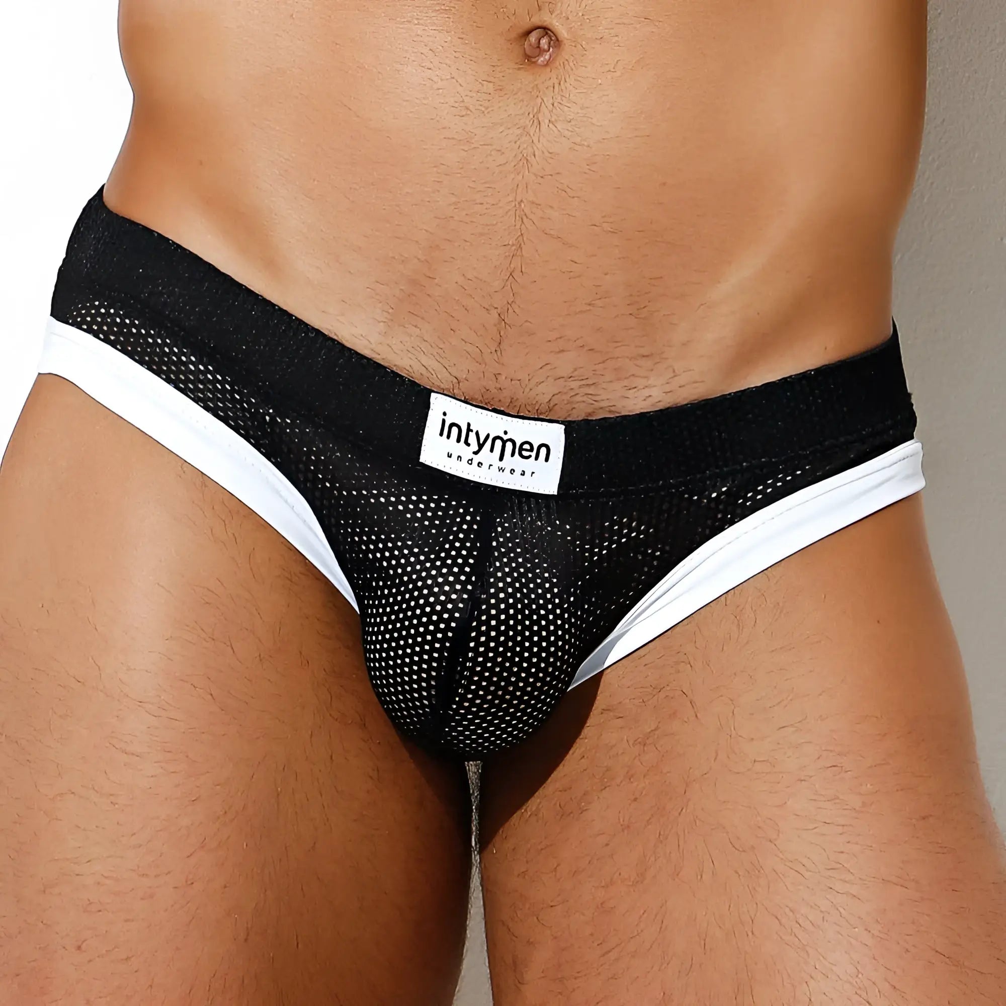 Black mesh briefs with white trim and intymen branded label in the front for the intymen ine022 jockstrap