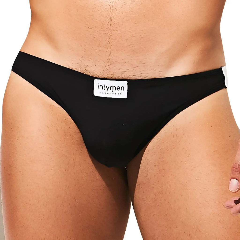 Intymen INE027 jockstrap in black with white label and trim designed for comfortable support and style