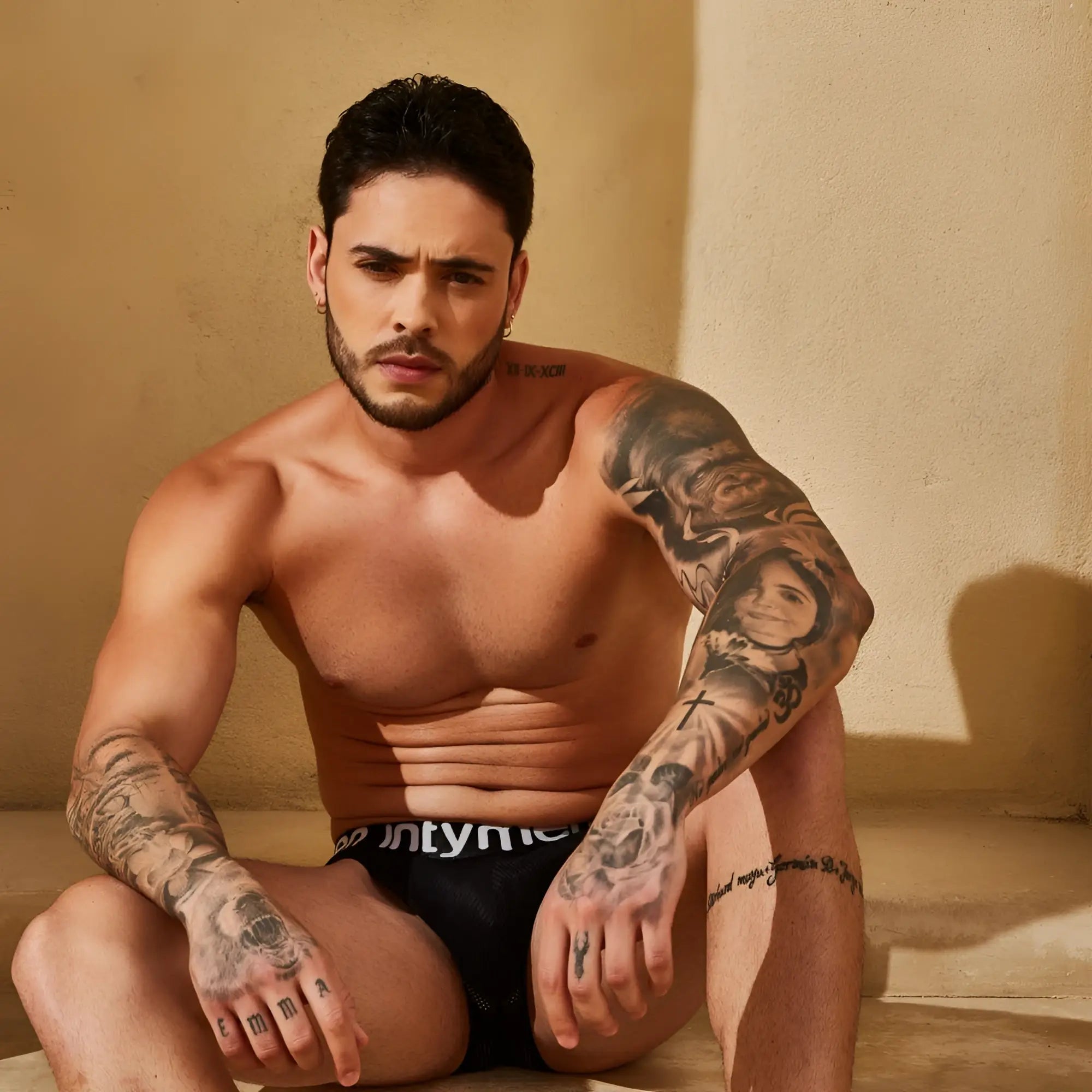 Black briefs with white intyner branding from intymen ing096 boxer featuring comfortable stretch fabric