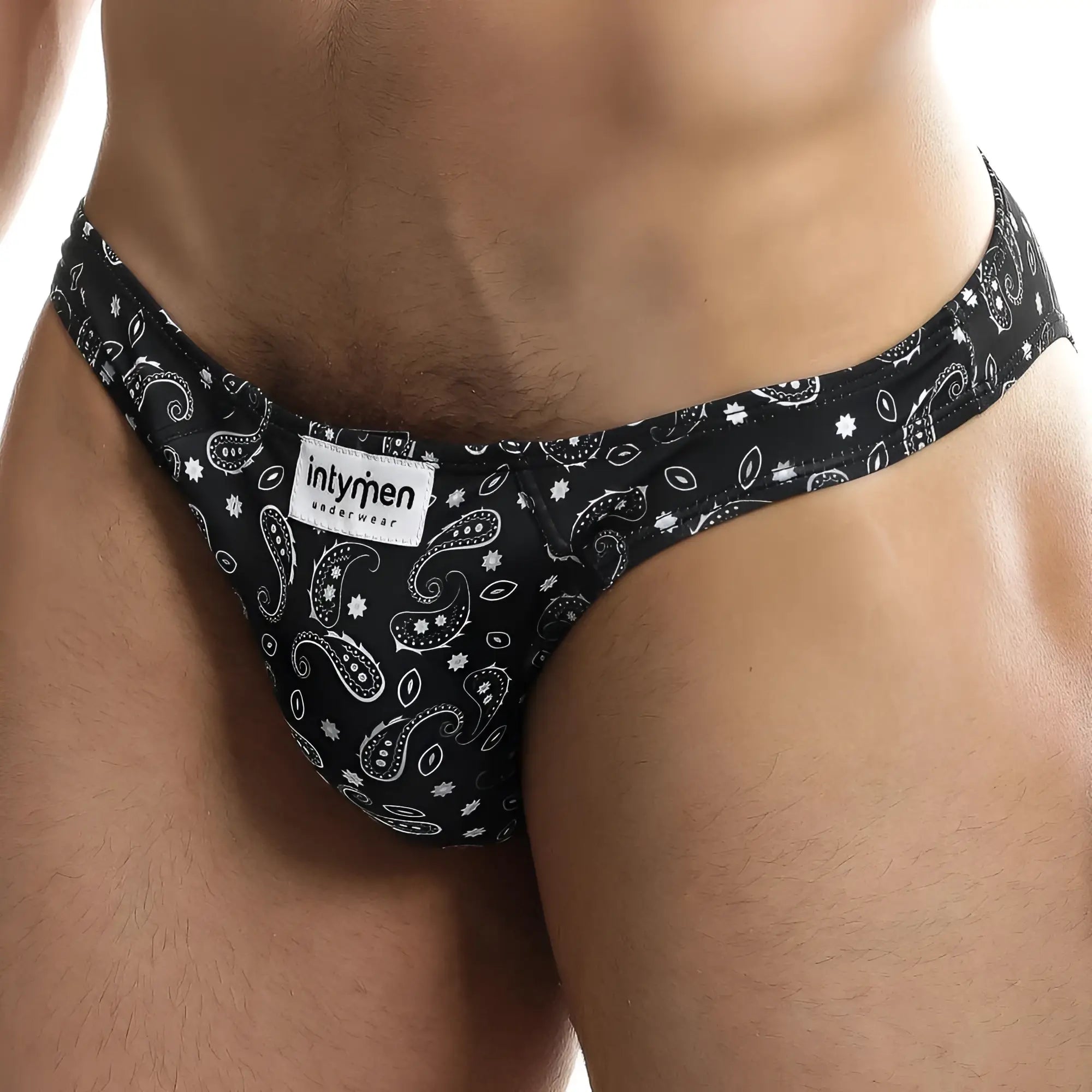 Black bandana-patterned men’s briefs with white paisley and star motifs featuring intymen branded label