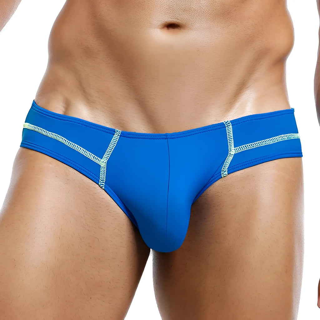 Bright blue Intymen INJ044 brief swim trunks with light green zigzag stitching along the sides