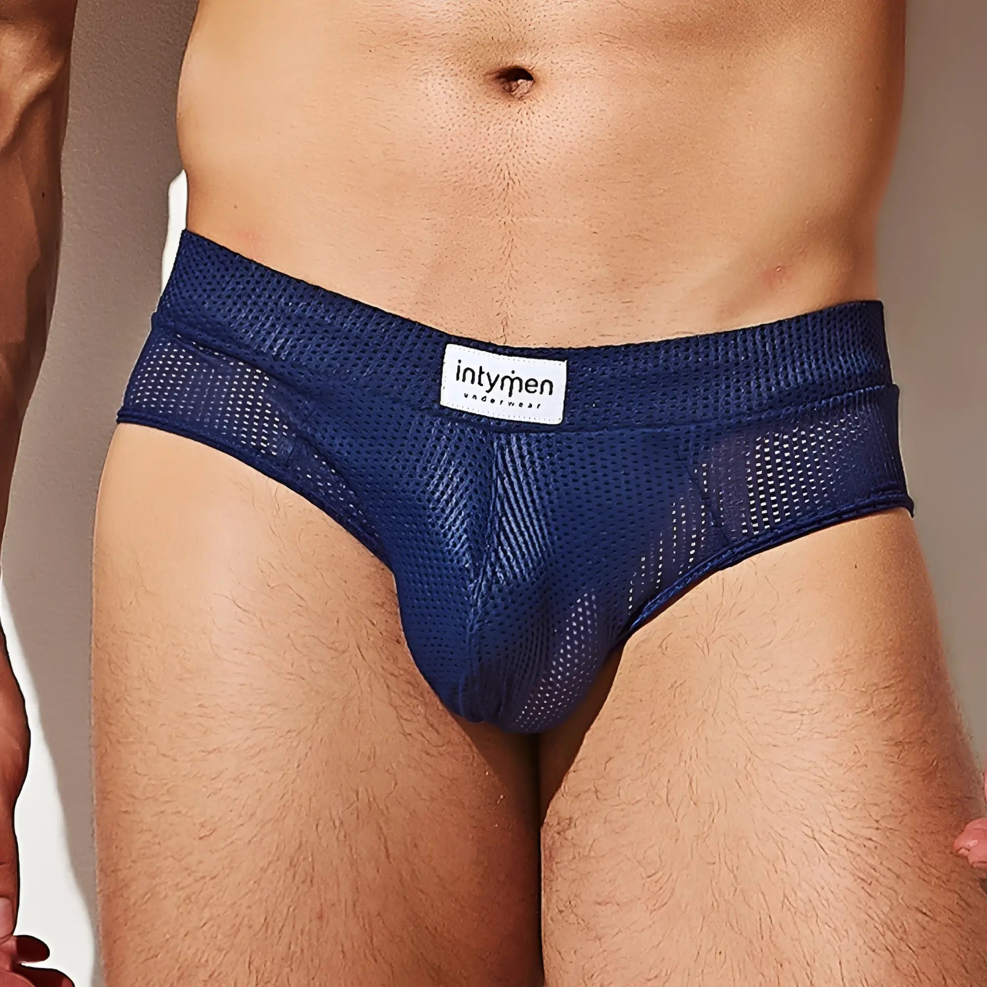 Navy blue mesh briefs with a white intymen label featuring breathable fabric and comfortable fit for everyday wear