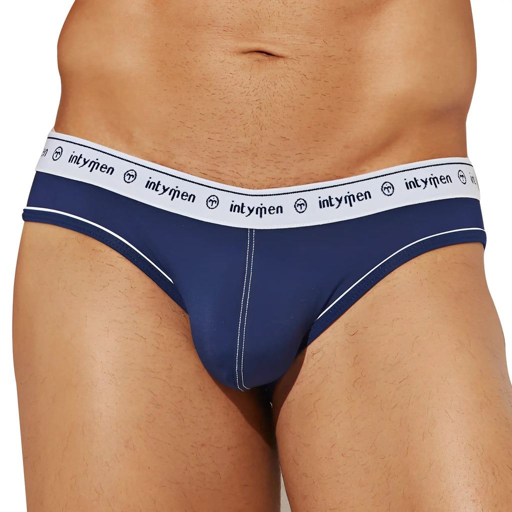 Navy blue Intymen INJ086 brief with white elastic waistband featuring repeating logo and brand emblem