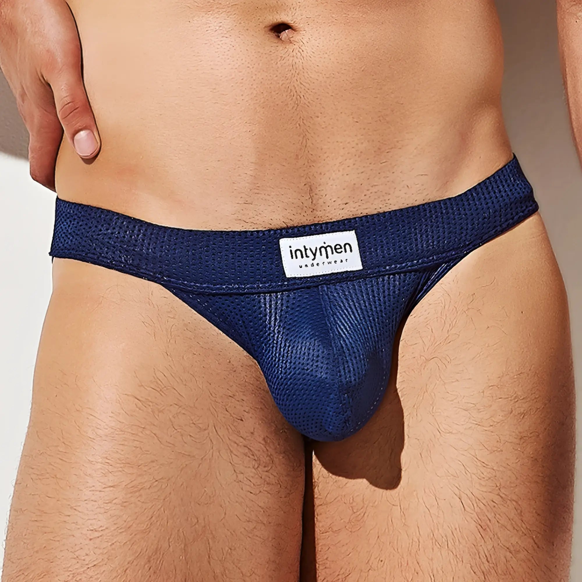 Deep blue mesh briefs with a white intymen brand label on the waistband from intymen ink014 thong collection