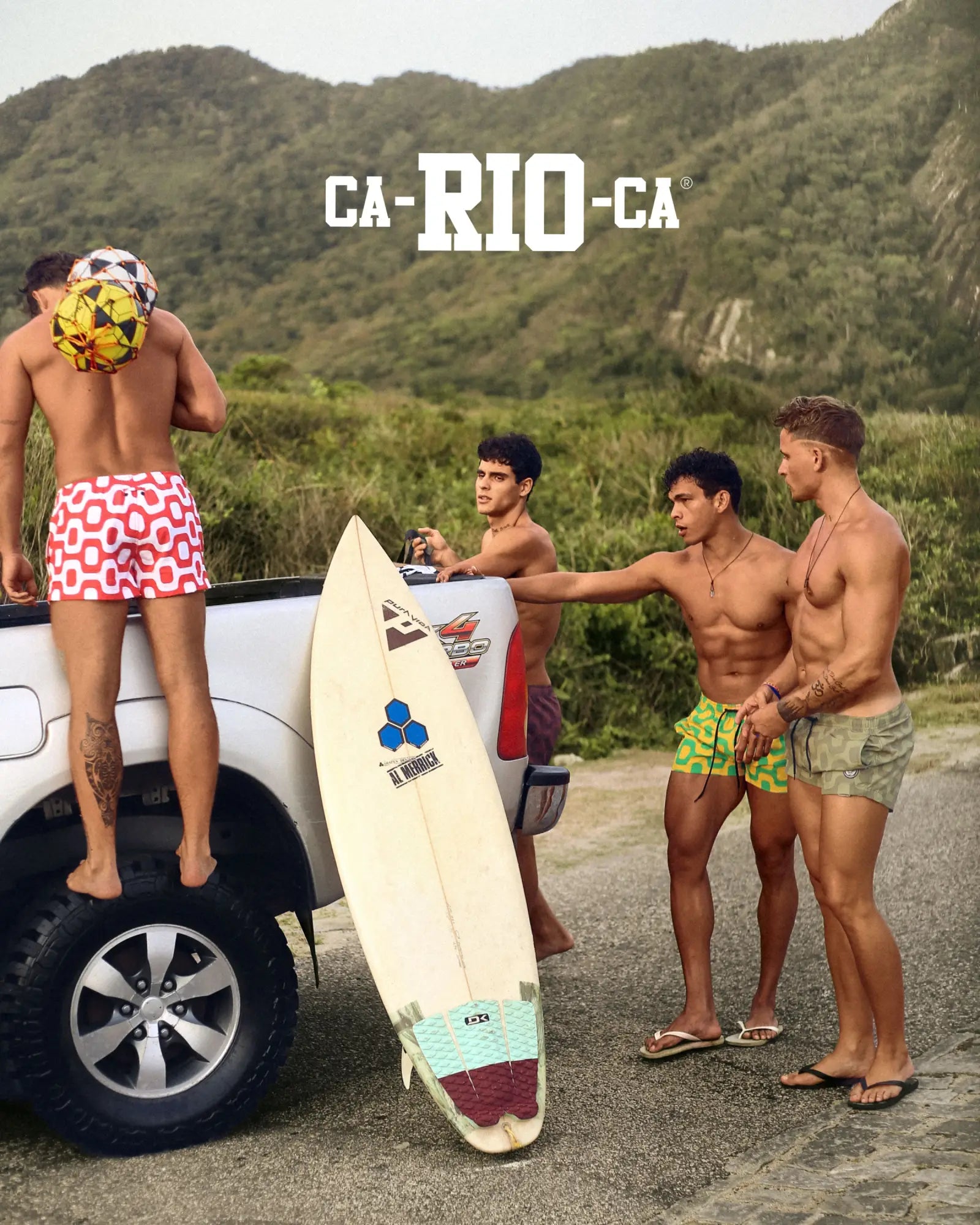 White surfboard with teal and maroon traction pad and blue triangular logo featured with ipanema pavement italian shorts