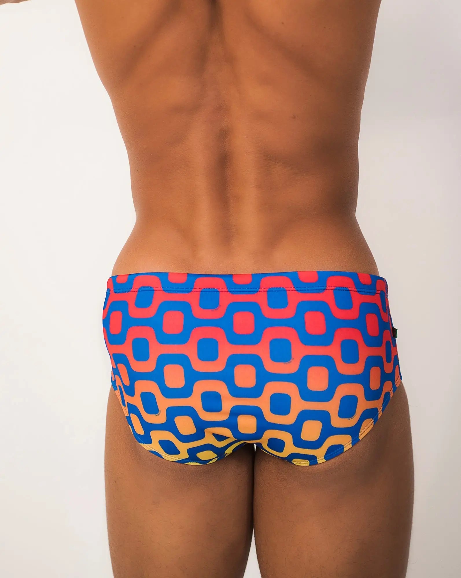 Ipanema Sunga men’s designer swimwear featuring vibrant blue and coral geometric-patterned swim trunks