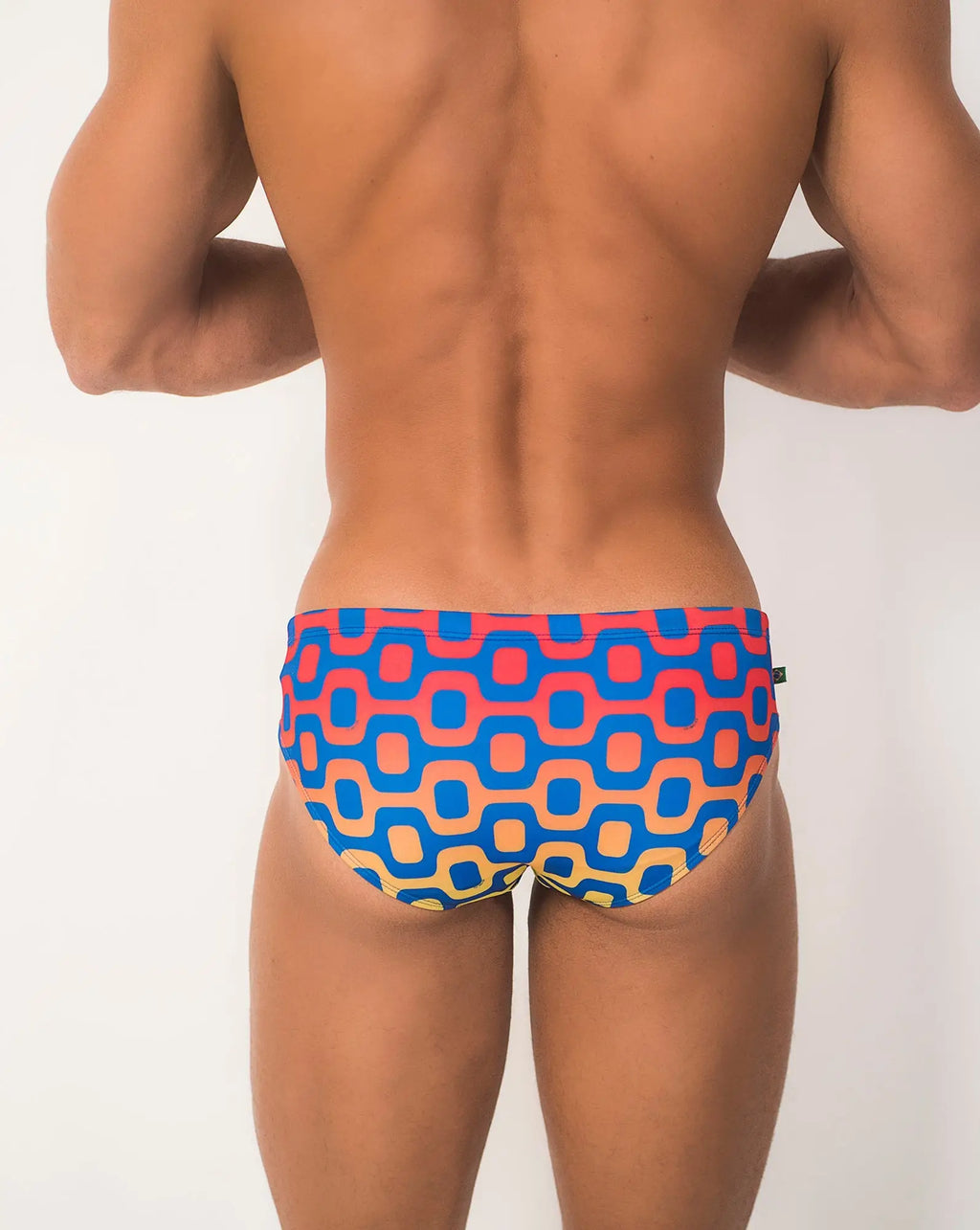 Ipanema sunga men’s designer swimwear featuring vibrant geometric-patterned swim trunks in blue coral pink and beige tones