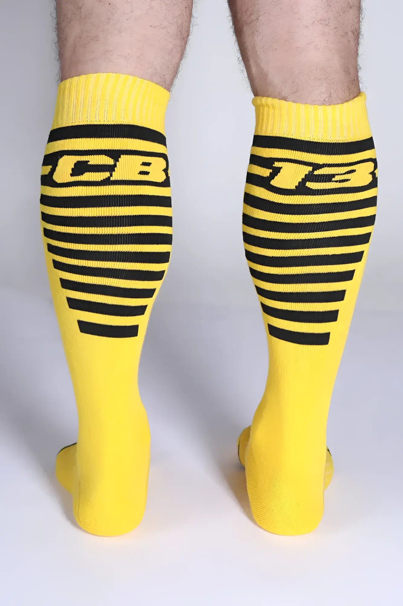 Iron Grip knee high sock in bright yellow with bold black horizontal stripes and cb-13 logo on the front side