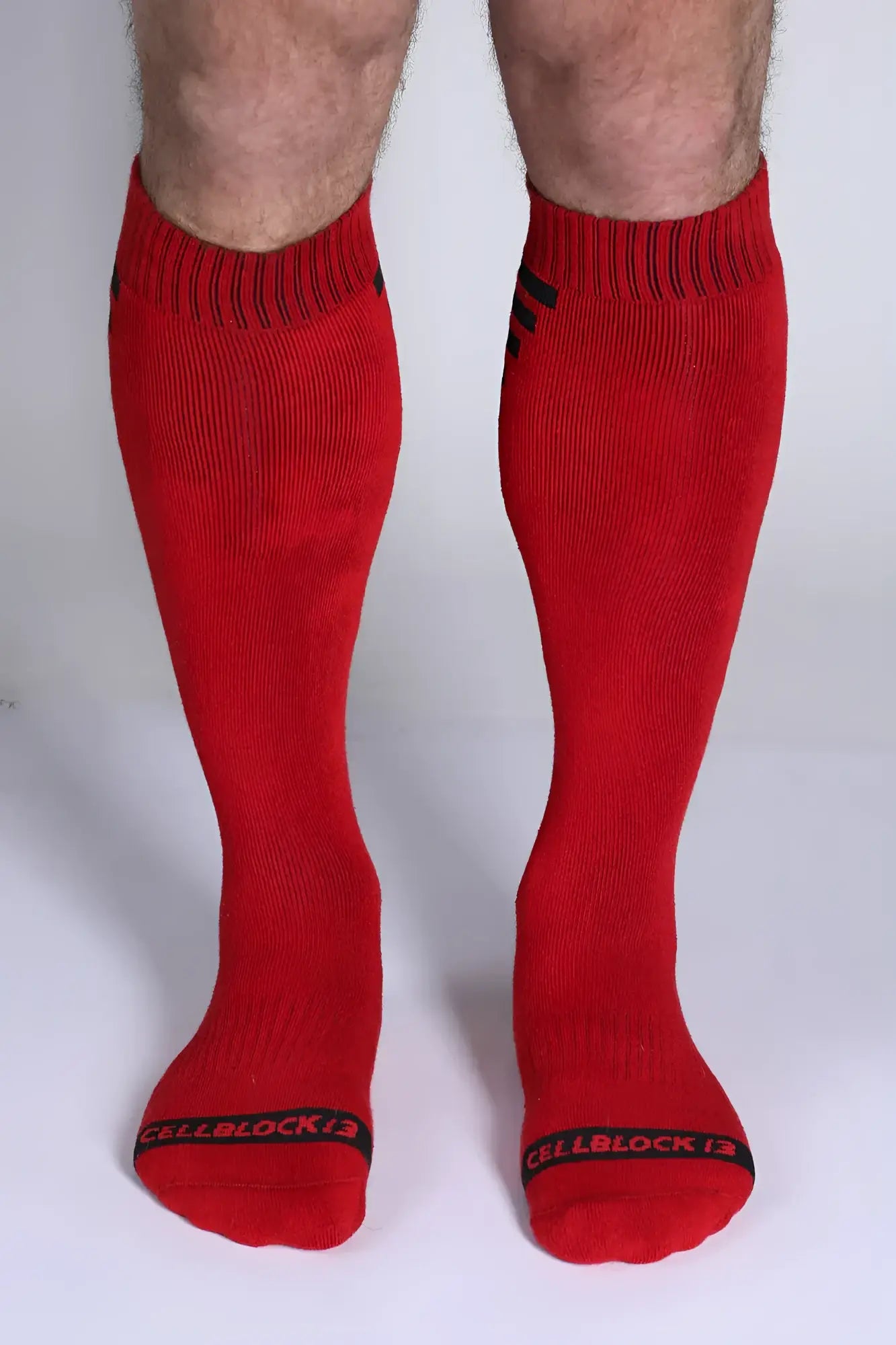 Iron grip knee high sock in red with black ribbed cuffs toe bands and cellblock 13 logo for athletic use
