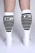 White iron grip knee high socks with black horizontal stripes and bold cb or 13 lettering on the upper leg
