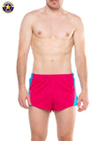 A j javelin field short bright pink athletic shorts with blue side panels made from lightweight synthetic fabric