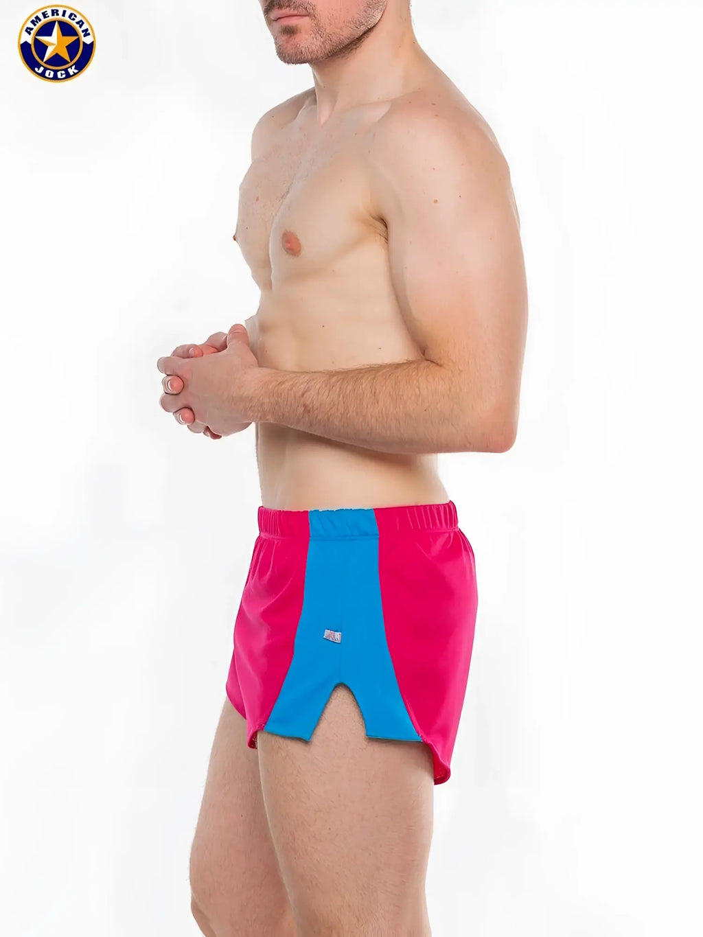 A j javelin field short in bright pink and blue with elastic waistband and bold color-block design for athletic use