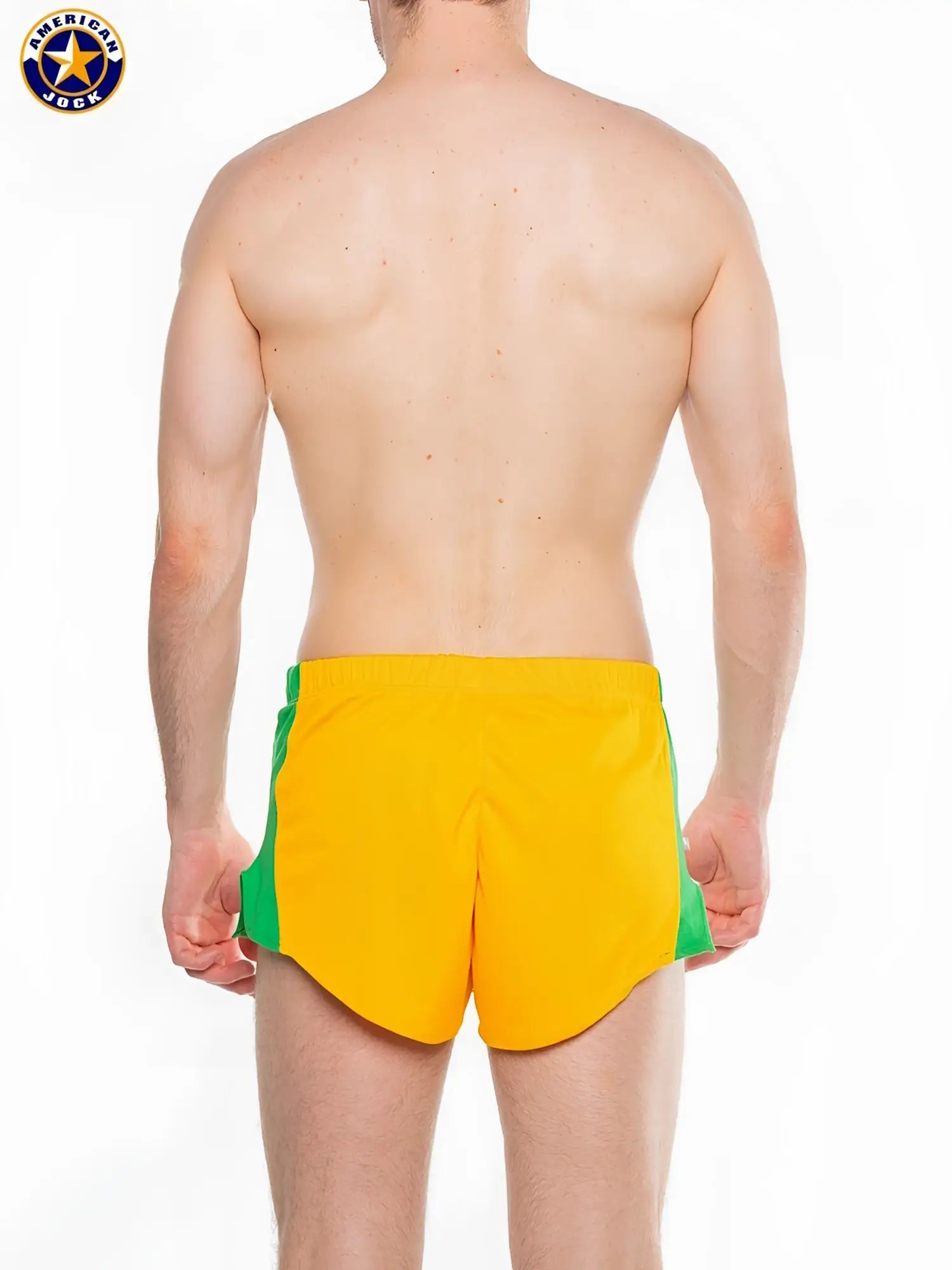 Bright yellow a j javelin field short with green side panels and a classic american jock logo on the left thigh
