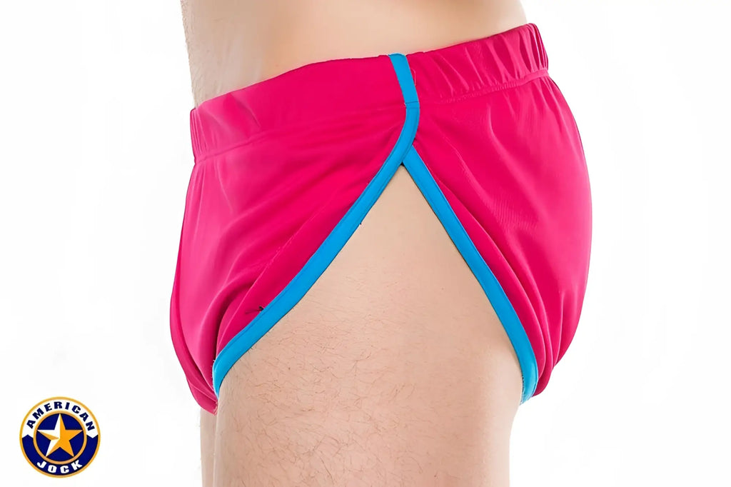 Bright pink a j javelin side split american jock swim trunks with bold blue trim for active swimwear use