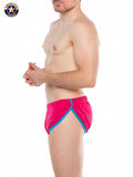 Bright pink American yoga swim trunks with bold blue trim in A J Javelin side split short design