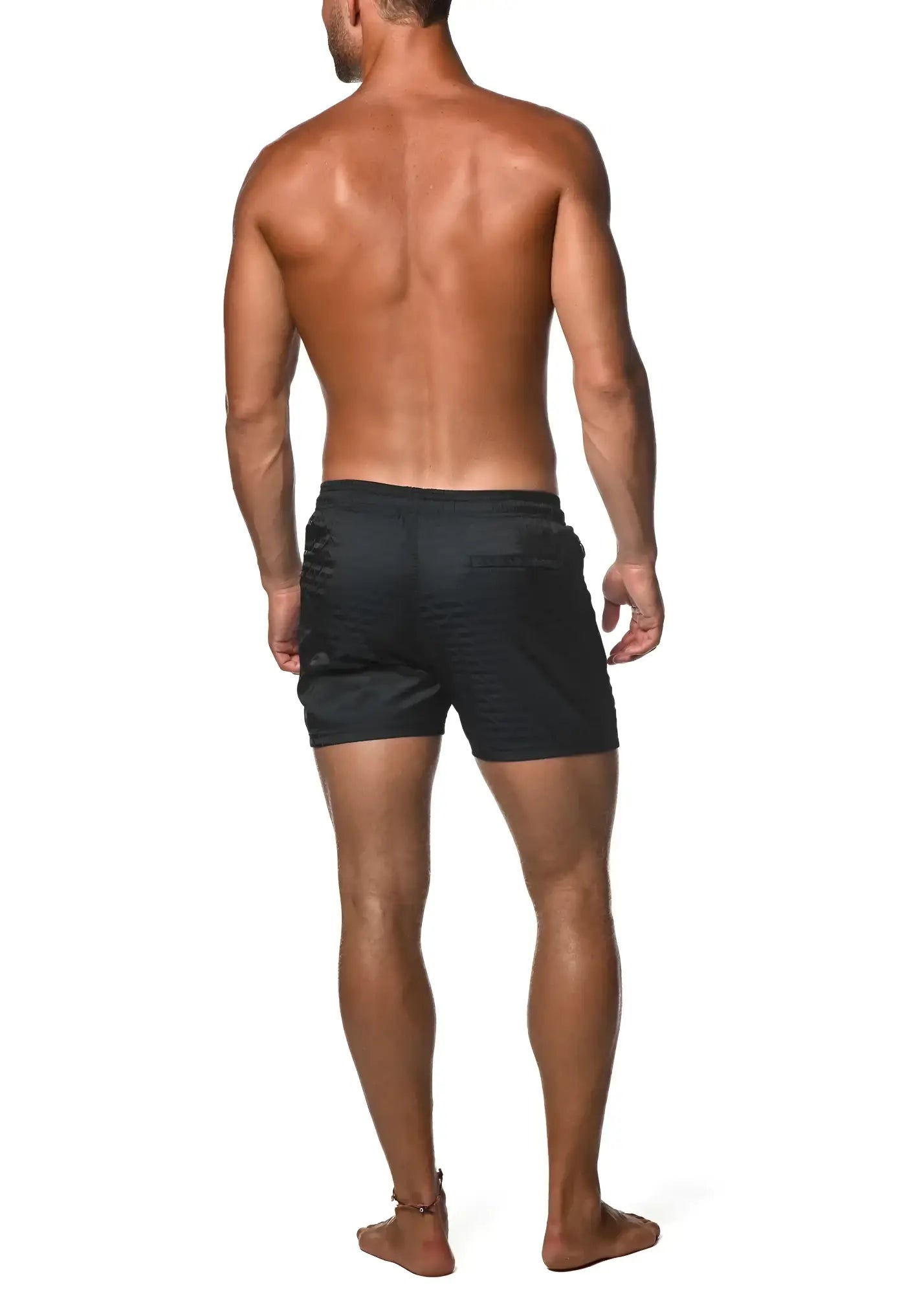 Black jacquard stretch swim shorts with ribbed fabric and subtle logo on the back pocket shown from the back side