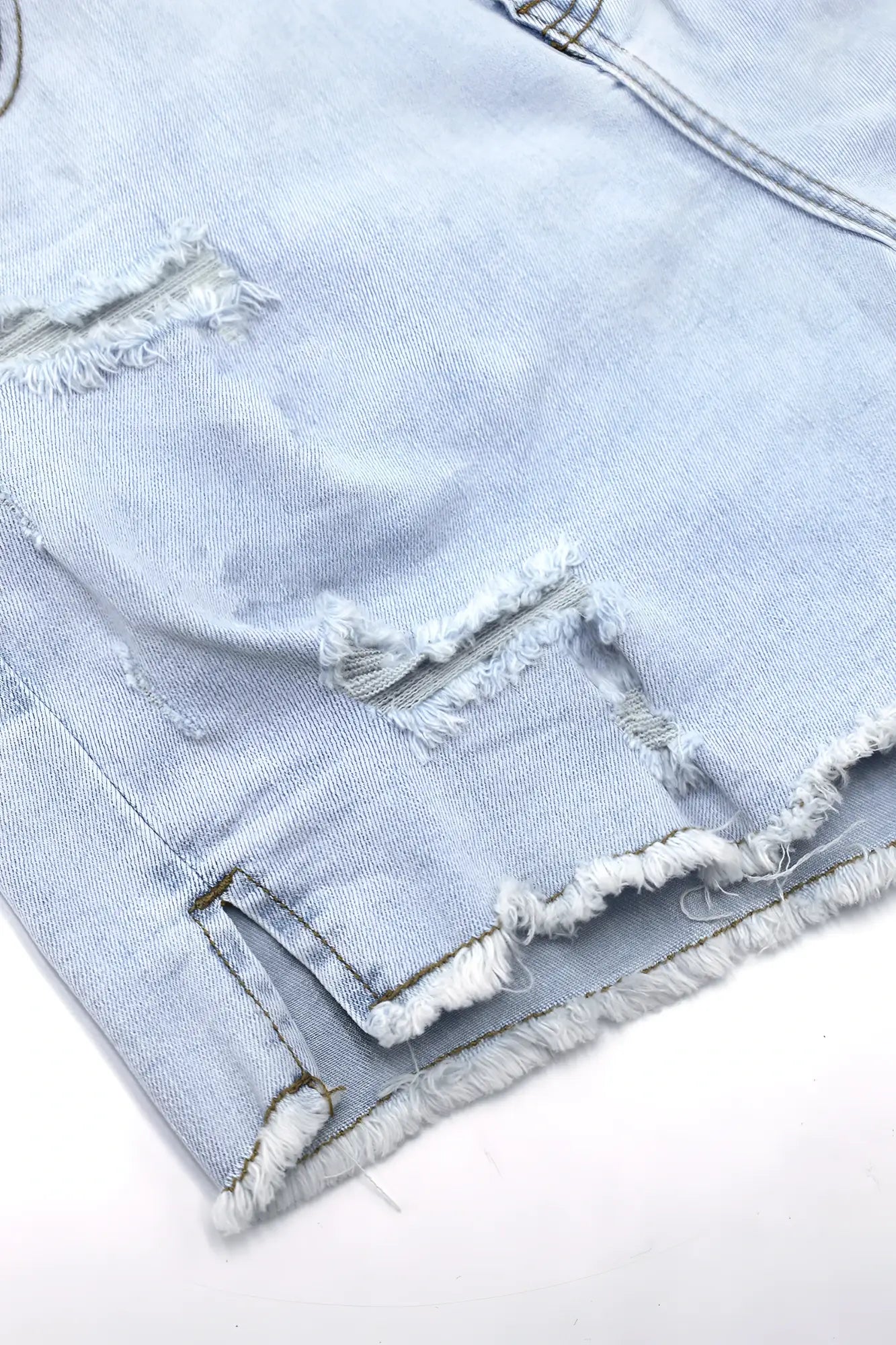 Light sky blue jaded 3.5 inch denim short shorts with frayed distressed edges and raw hem in light-wash denim