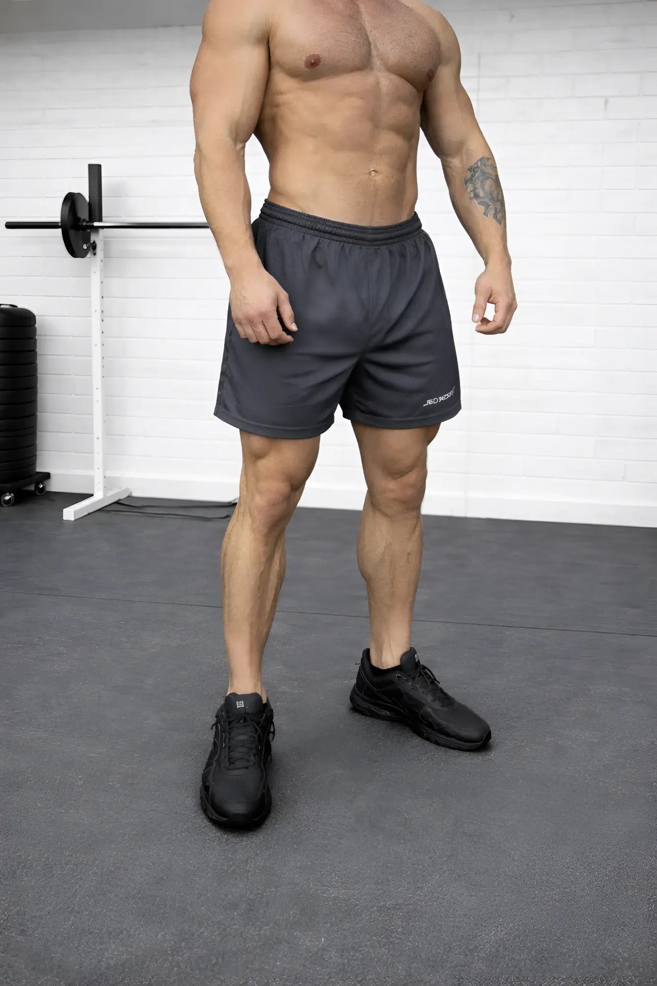 Dark gray 5 inch double layer mesh basketball shorts with subtle logo on lower left leg designed for performance