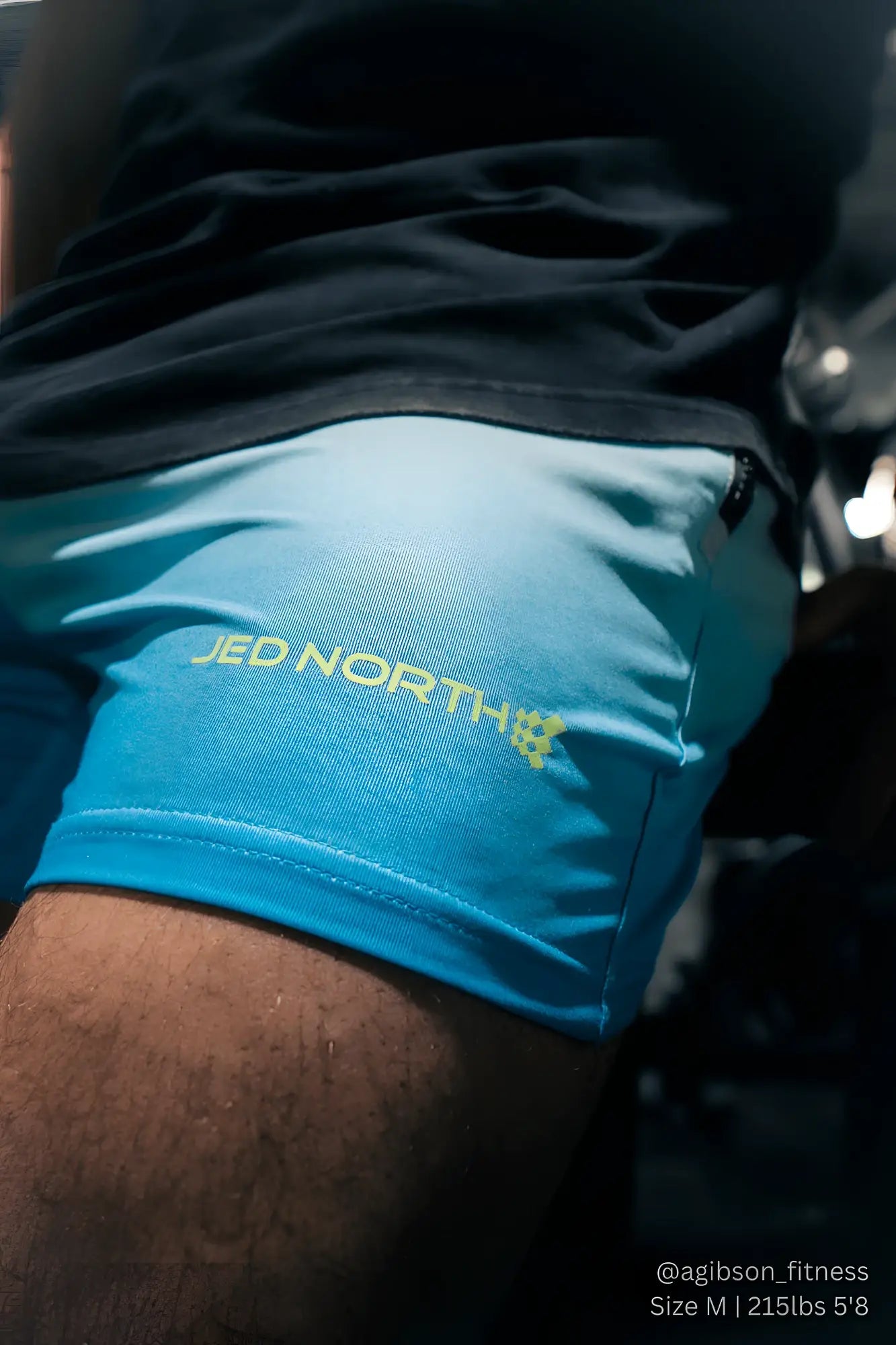 Bright blue jed north agile bodybuilding 4 inch shorts with subtle gradient and yellow logo embroidered on side
