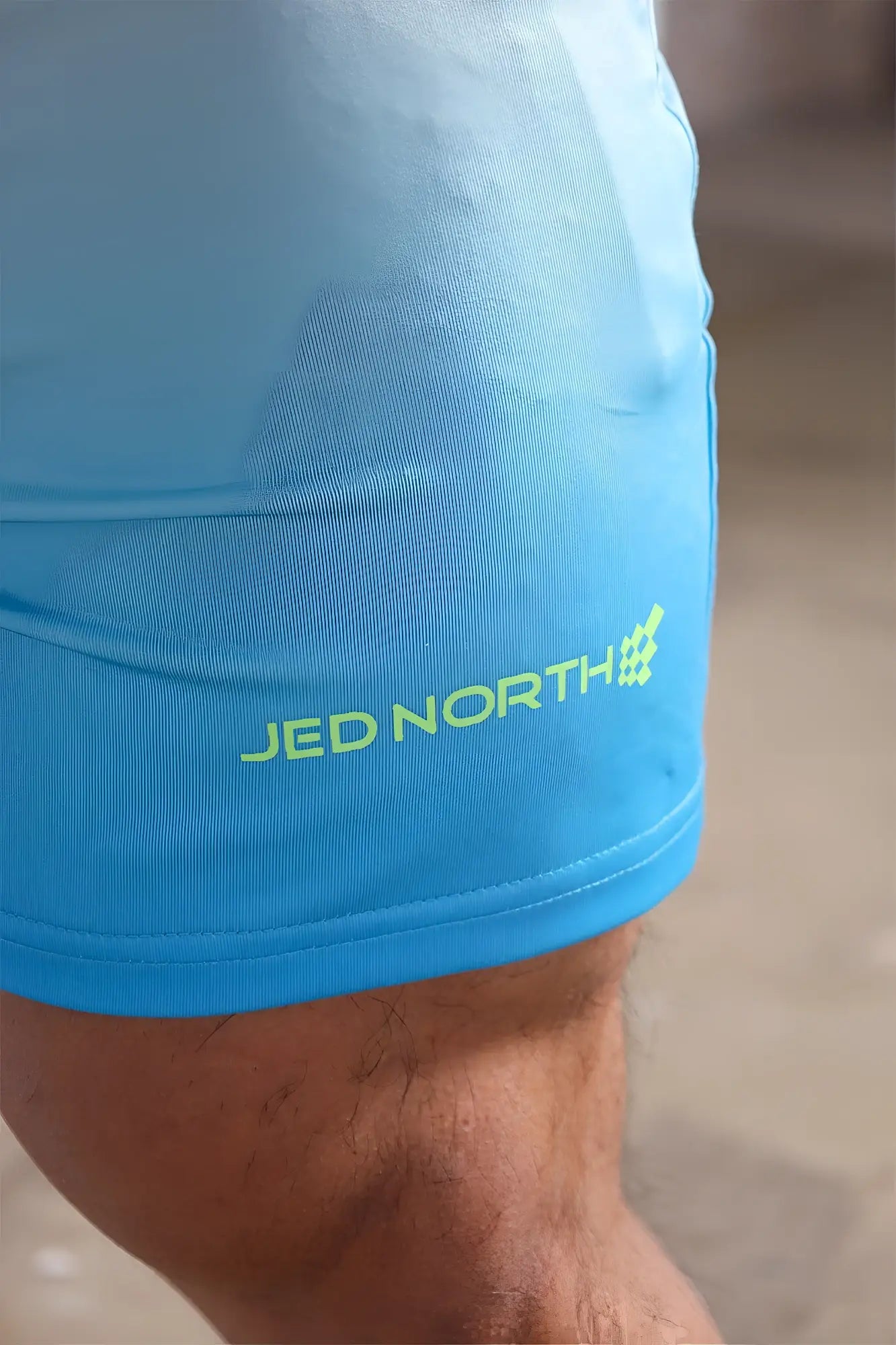 Bright blue jed north agile bodybuilding 4 inch athletic shorts with neon green logo and zipper pockets