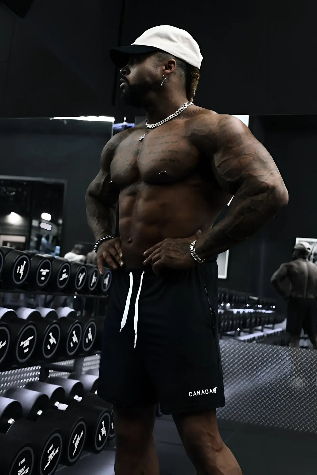 Black agile bodybuilding 4 inch athletic shorts with white drawstrings zipper pockets and canada logo on lower left leg