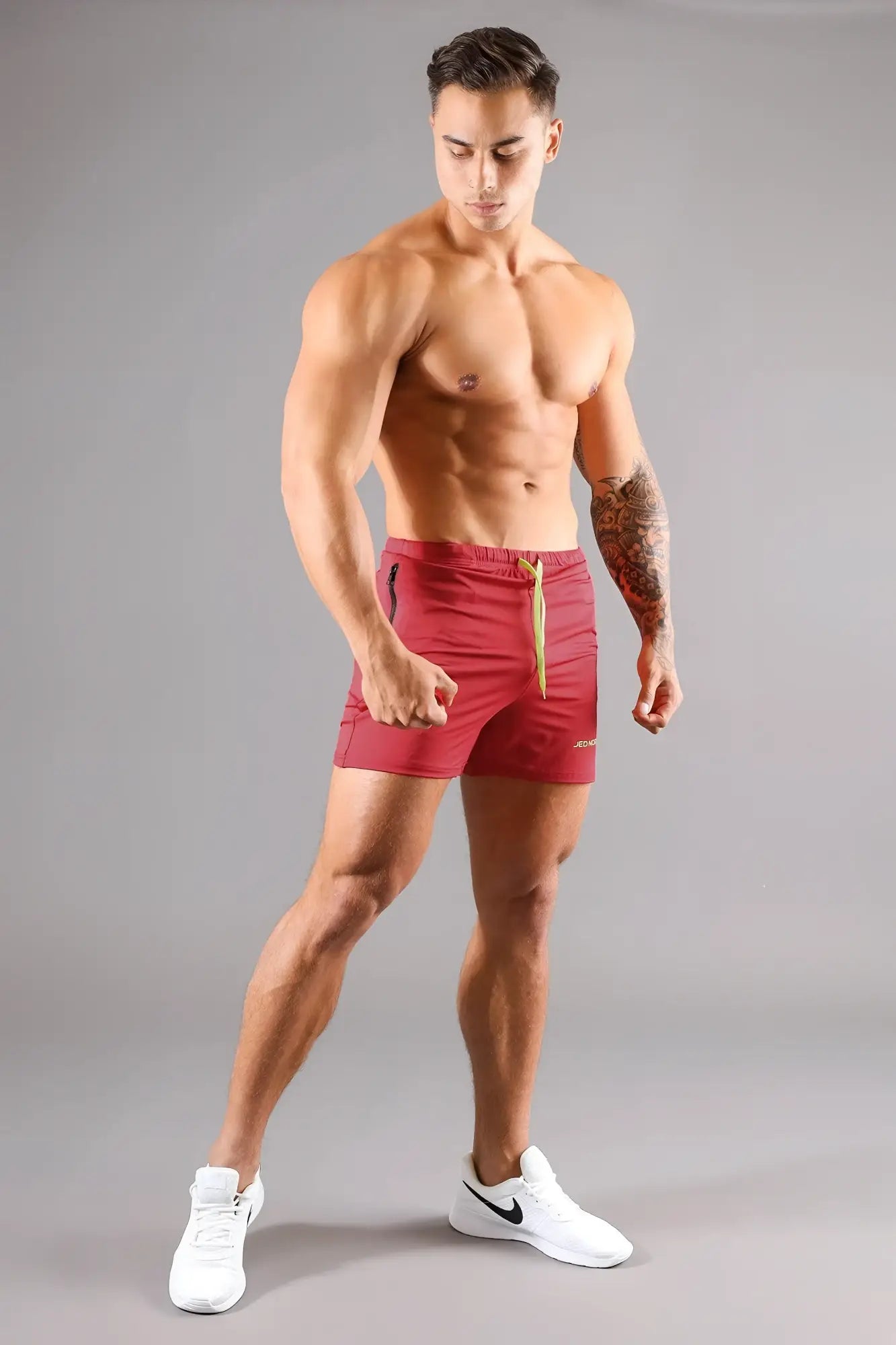 Jed North agile bodybuilding crimson red athletic shorts with gold drawstring and black side panels with zipper pockets