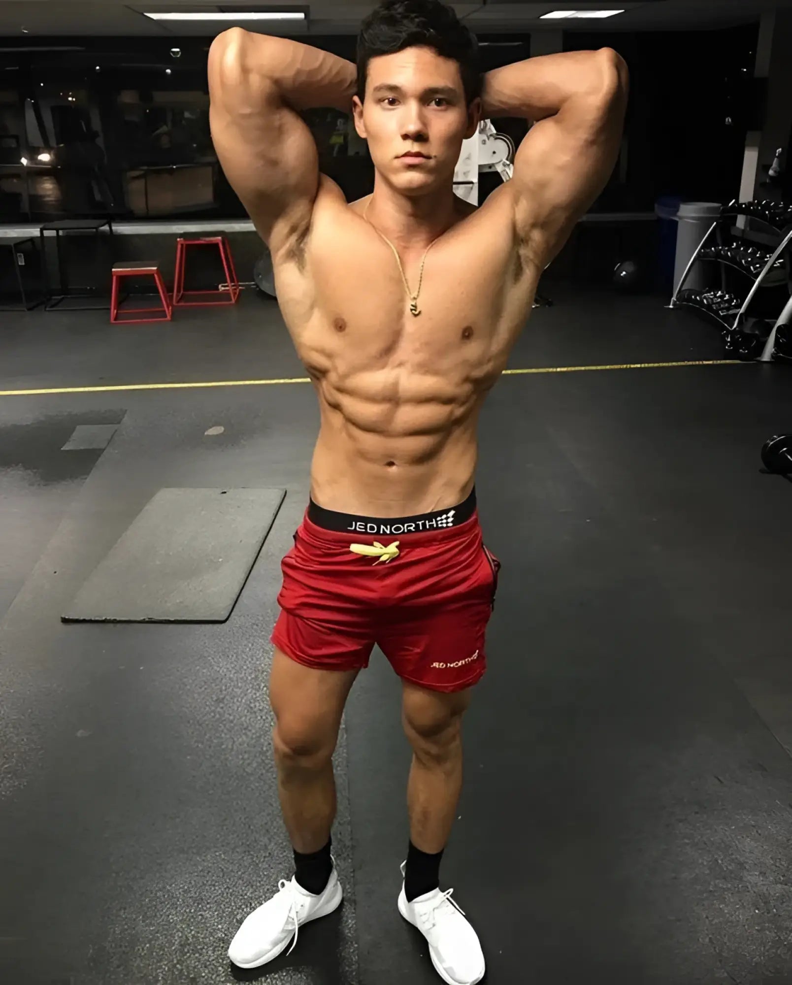 Red athletic Jed North Agile bodybuilding 4 inch shorts with black waistband and gold logo featuring zipper pockets