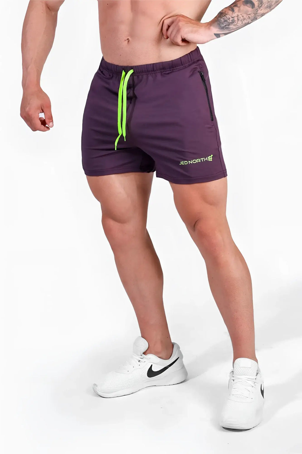 Purple jed north agile bodybuilding shorts with neon green drawstrings and zipper pockets for active use
