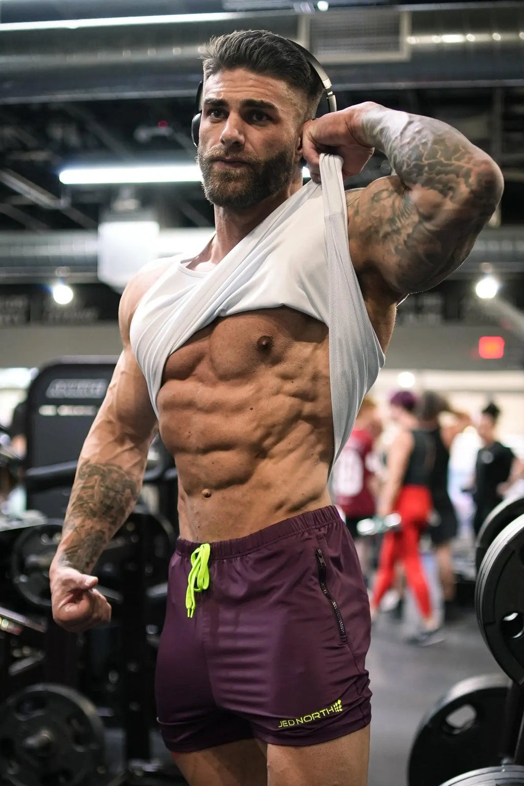 Dark purple jed north agile bodybuilding 4 inch shorts with neon green drawstrings and zipper pockets