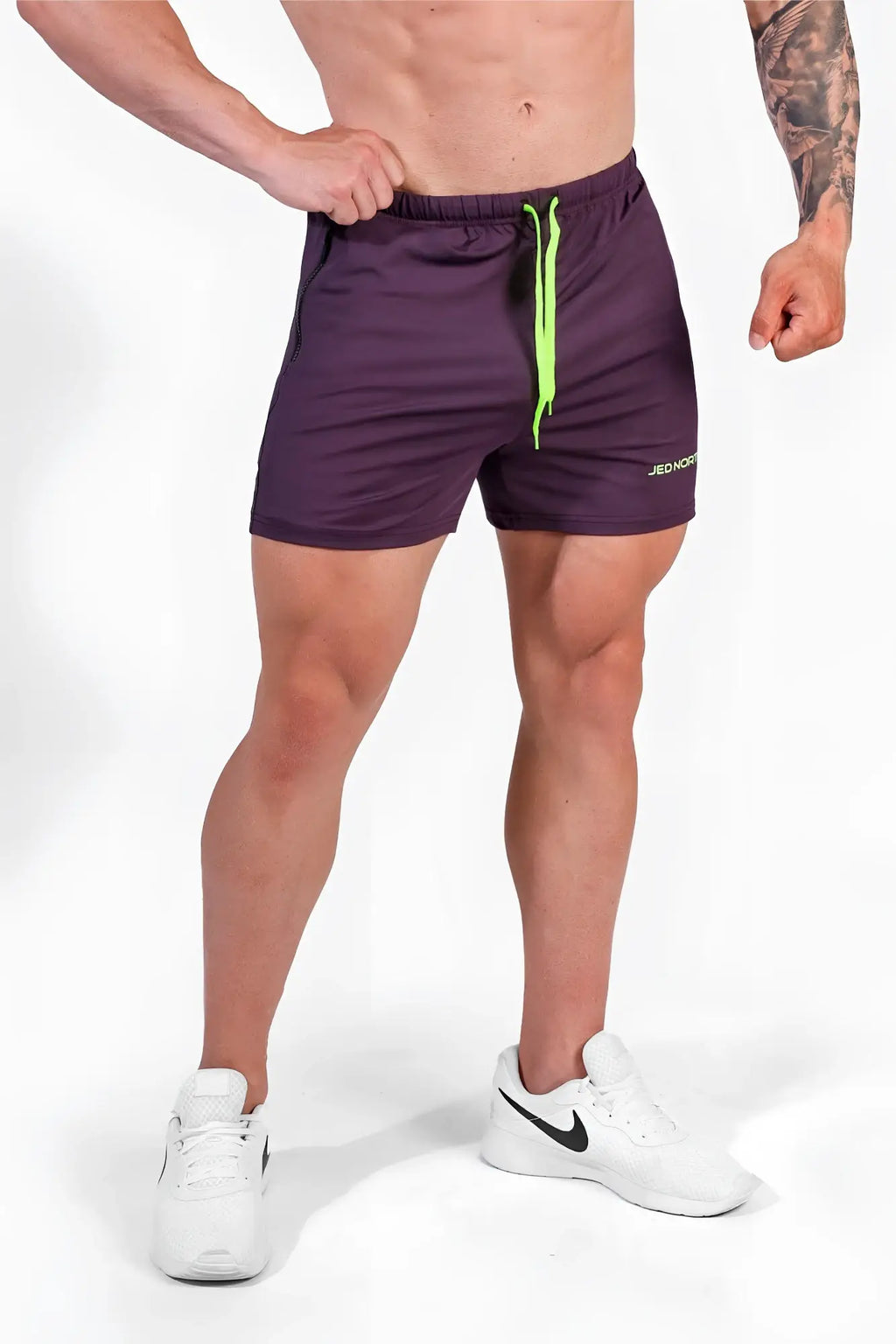 Purple jed north agile bodybuilding 4 inch shorts with neon green drawstrings and zipper pockets for workouts