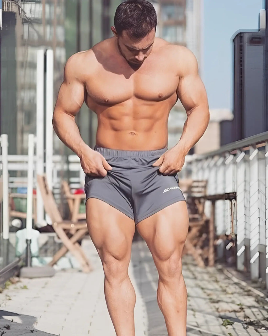 Gray jed north agile bodybuilding 4 inch athletic shorts with zipper pockets and subtle white logo on lower right leg