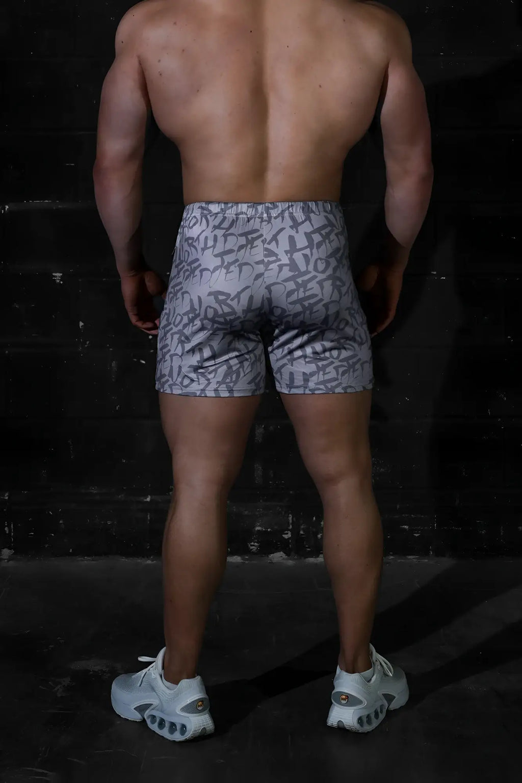 Gray Jed North Agile bodybuilding shorts with black graffiti-style lettering and zipper pockets designed for active wear