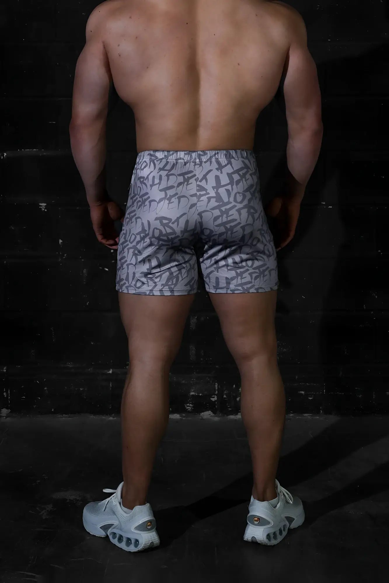 Gray Jed North Agile bodybuilding shorts with black graffiti-style lettering and zipper pockets designed for active wear