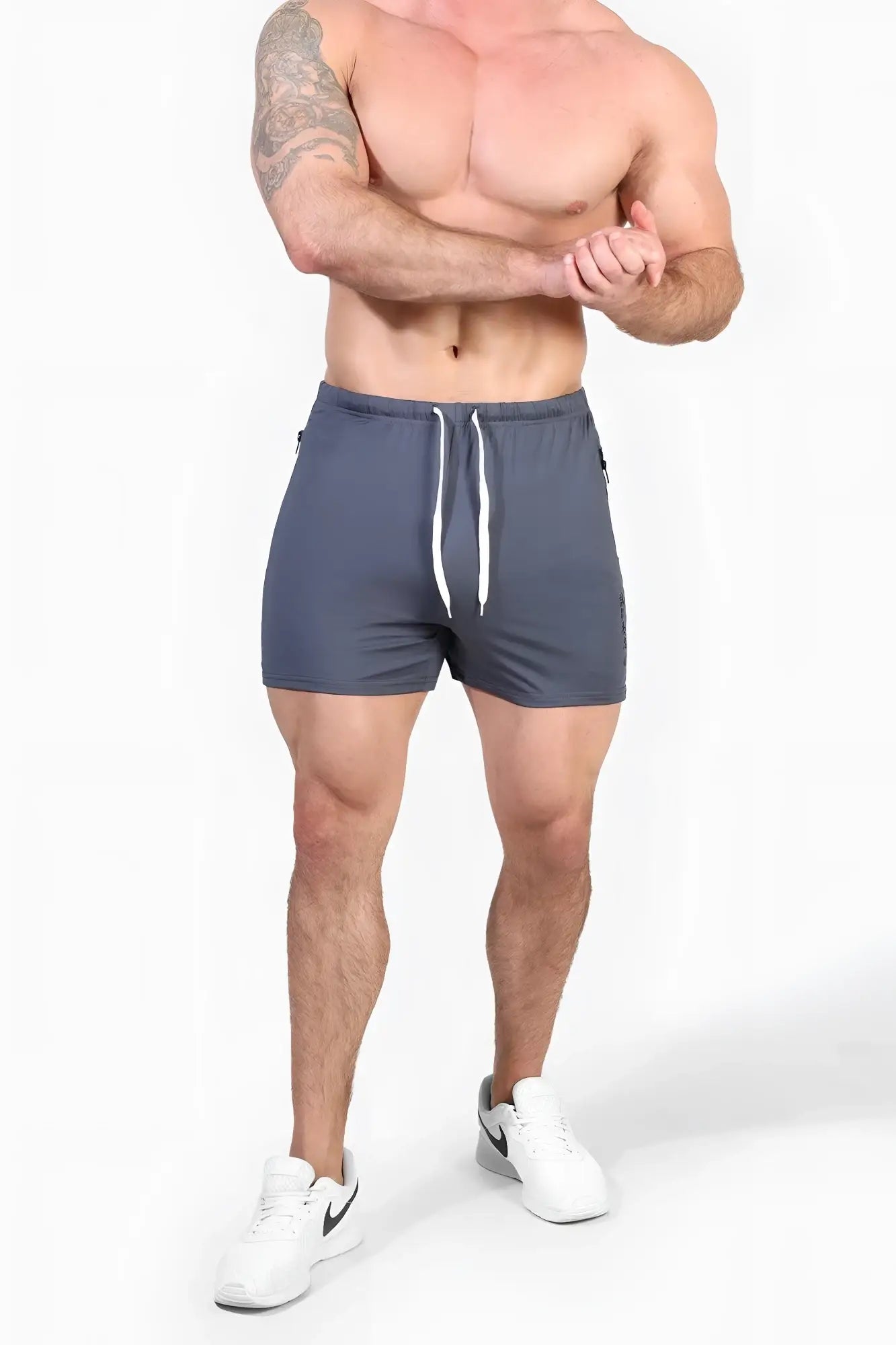 Dark gray agile bodybuilding 4 inch shorts with white drawstrings and subtle side zipper pockets for gym use
