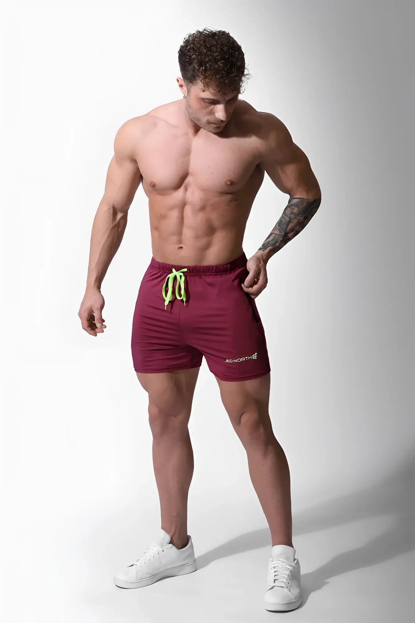 Maroon jed north agile bodybuilding 4 inch shorts with neon green drawstrings small white logo and zipper pockets