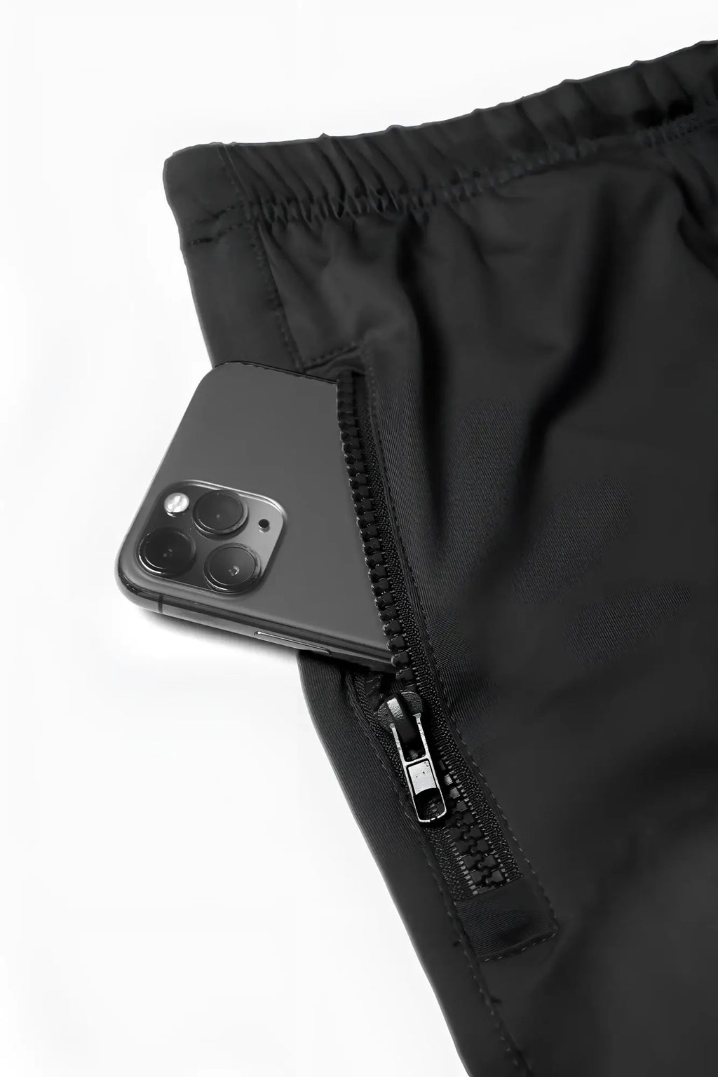 Black jed north agile bodybuilding 4 inch shorts with zippered side pocket holding dark gray smartphone