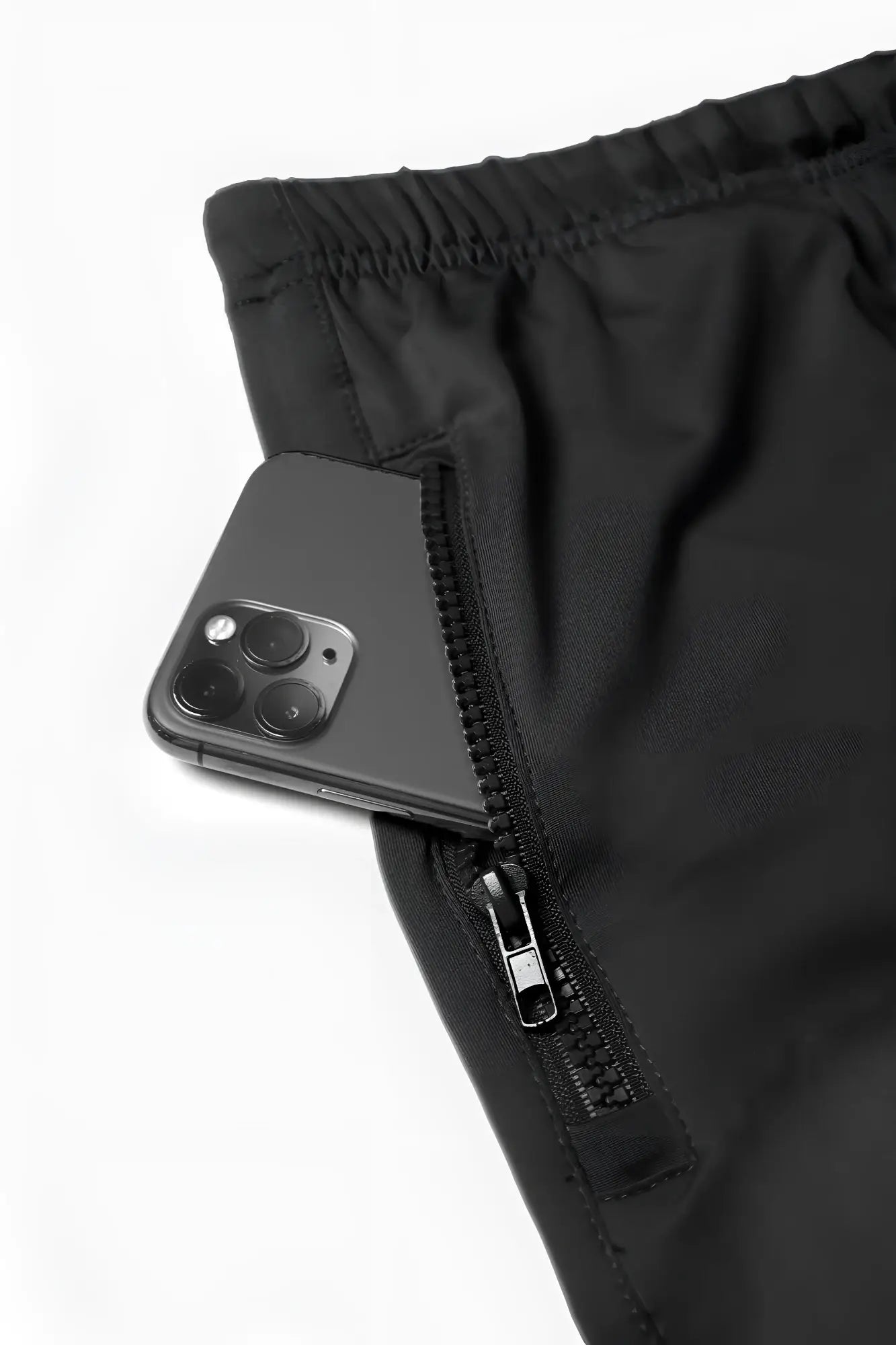 Black jed north agile bodybuilding 4 inch shorts with zippered side pocket holding dark gray smartphone