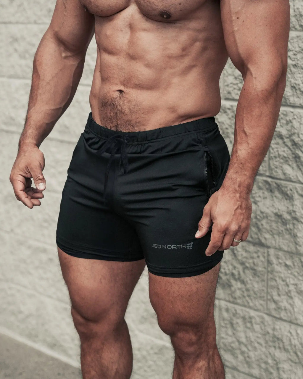 Black jed north agile bodybuilding 4 inch shorts with drawstring waistband, zipper pockets, and red north logo
