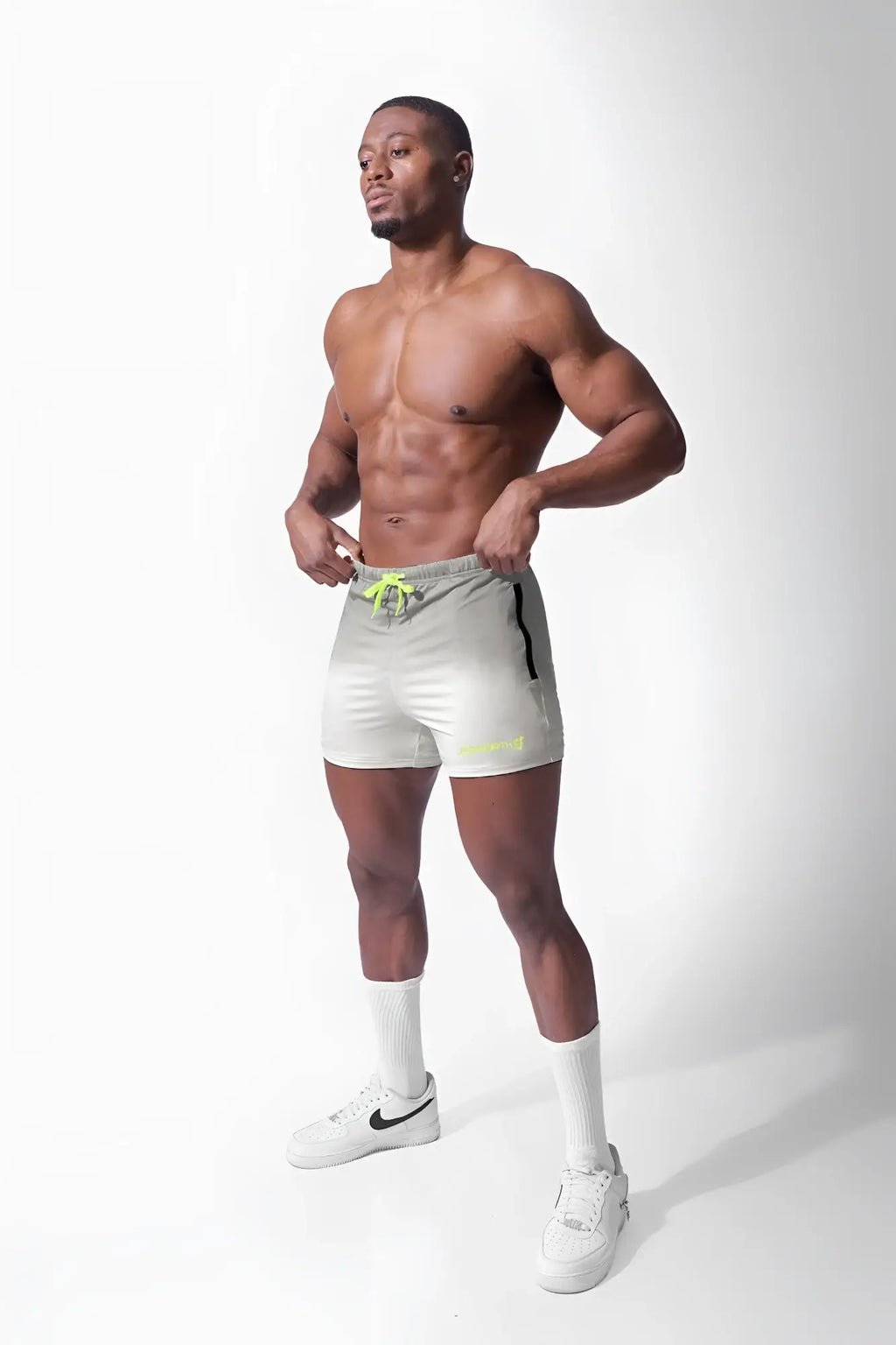 Light gray agile bodybuilding 4 inch shorts with neon yellow drawstring and black side stripe featuring zipper pockets