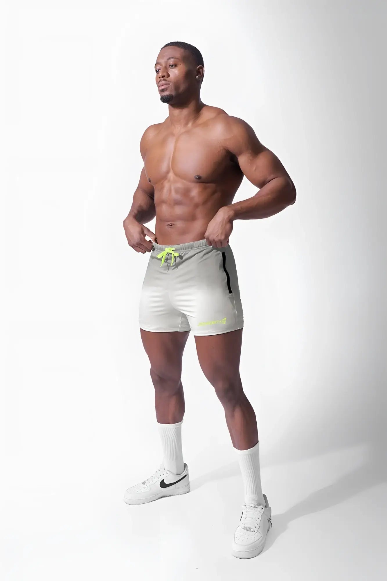Light gray agile bodybuilding 4 inch shorts with neon yellow drawstring and black side stripe featuring zipper pockets