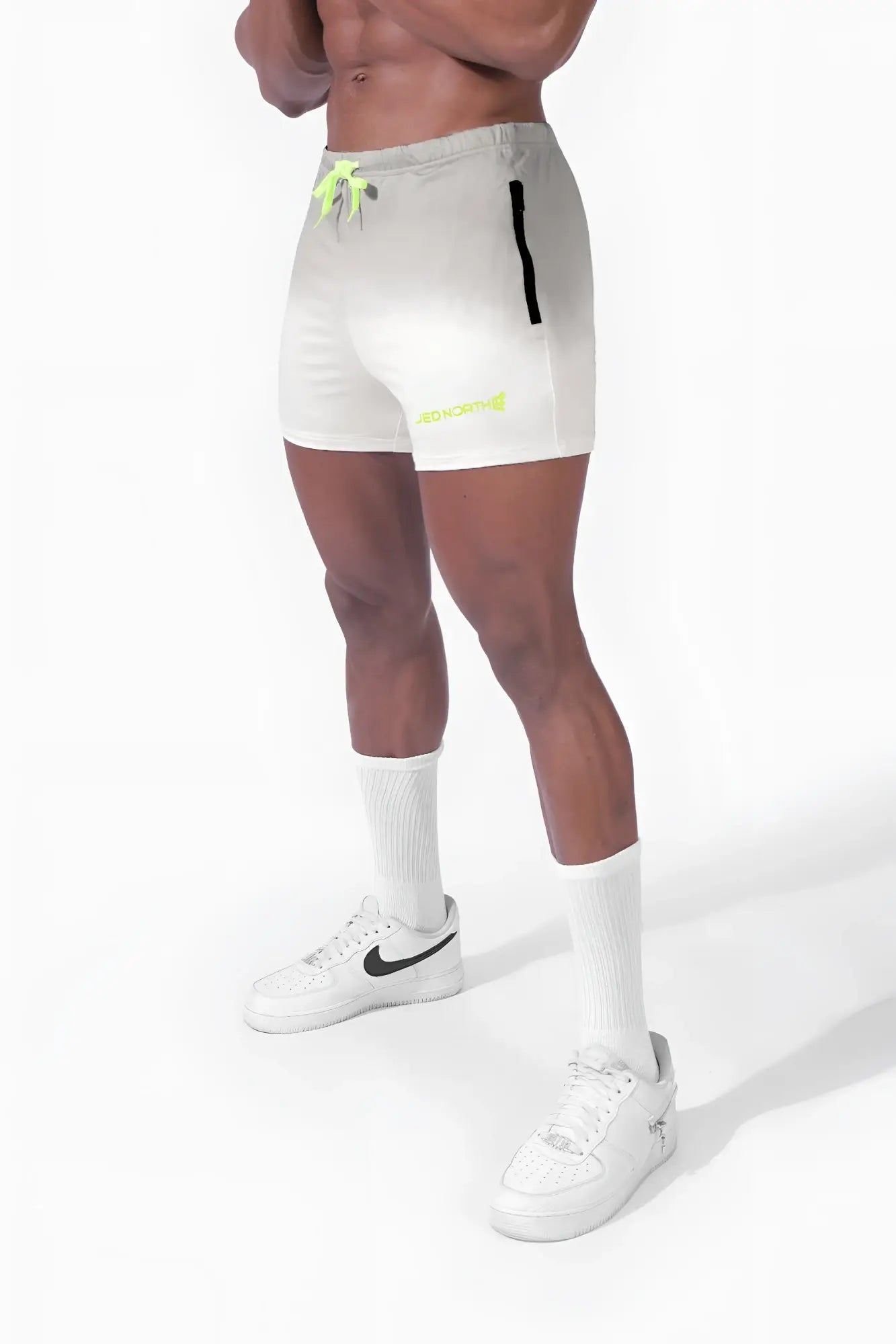 Agile Bodybuilding 4 inch white athletic shorts with neon green and black accents and side zipper pockets