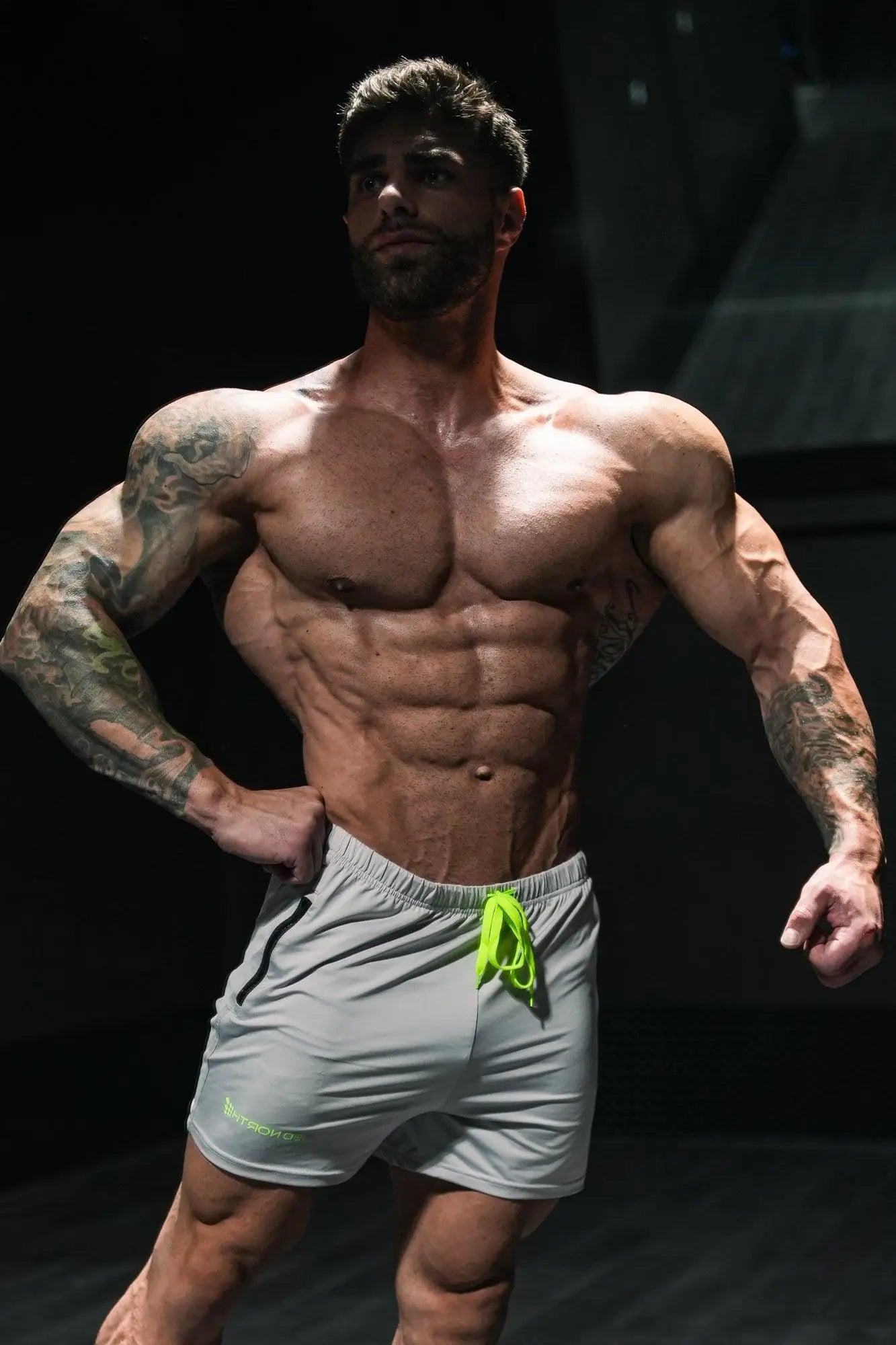 Gray jed north agile bodybuilding shorts with neon green drawstring black side stripe and zipper pockets